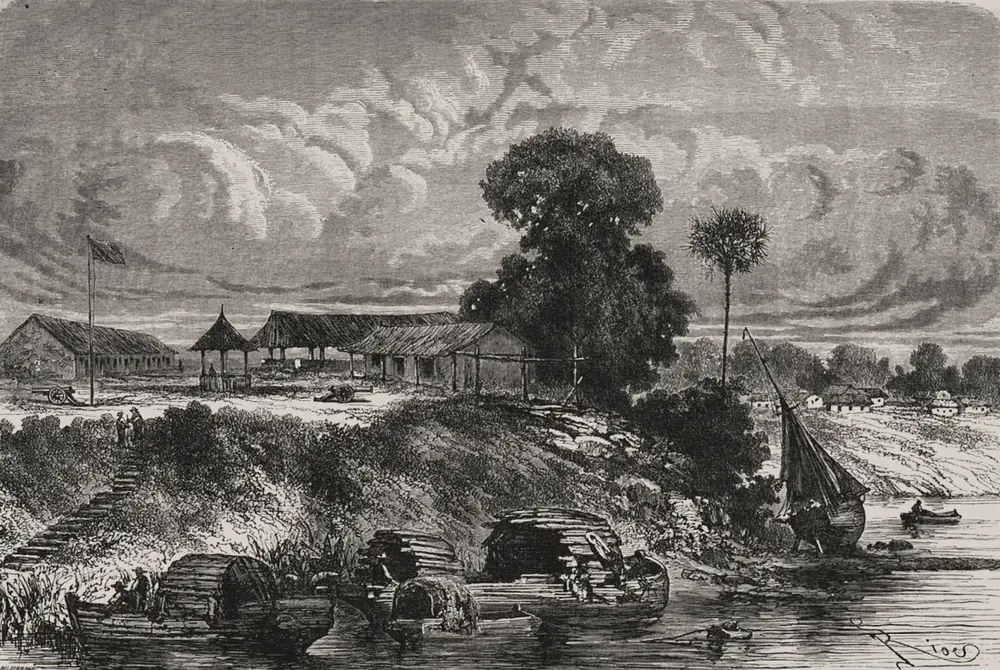 Grabado de 1867: en la orilla de un río ancho, varias canoas con techos de palma están amarradas al pie de una barranca; una escalera de tierra sube hasta un puesto con casas de techo de paja, una bandera en un mástil y dos cañones. A la derecha, un árbol grande, una palma, un velero varado y, al fondo, casas blancas del pueblo.